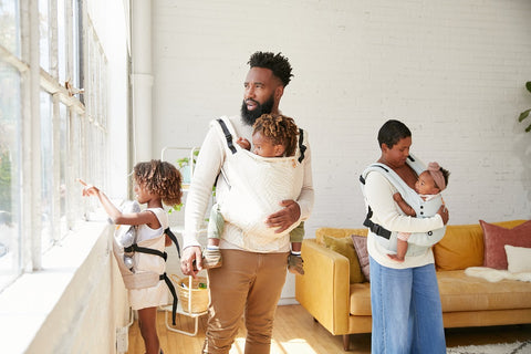 A family of five enjoying babywearing and the view outside.