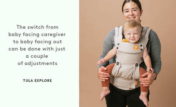 A mum carrying her Infant in outward facing position in the Tula Explore baby carrier