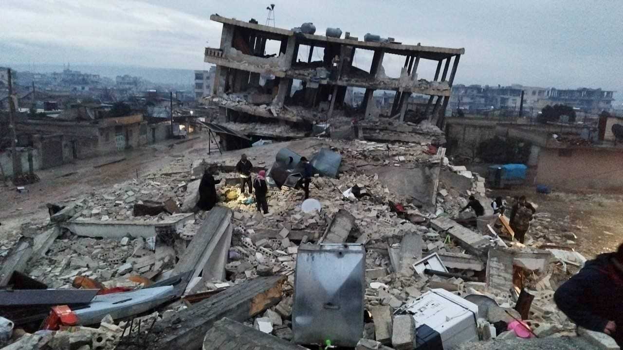 People search through rubble following an earthquake.