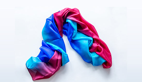 A crumpled silk scarf in vivid blue, pink, and purple colors.