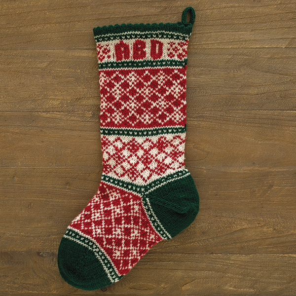 A needlepoint Christmas stocking kit that features red and white