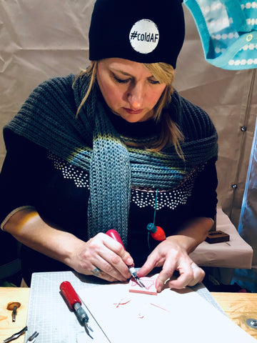 Jen hand-carving a MN stamp