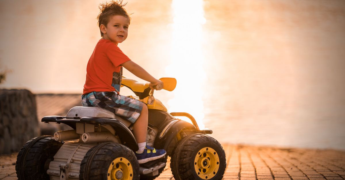 A boy riding an ATV ride on