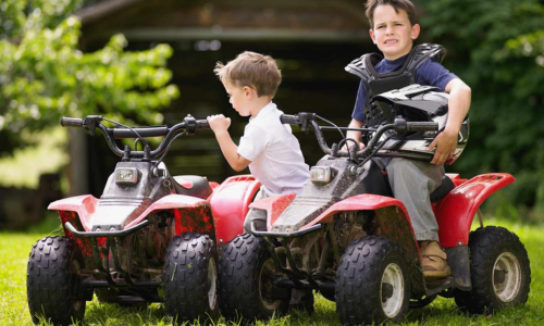 two boys riding on their quadbikes