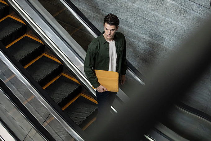 Image of a man holding his laptop