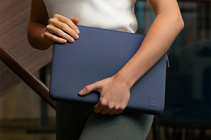 Image of a person carrying a laptop