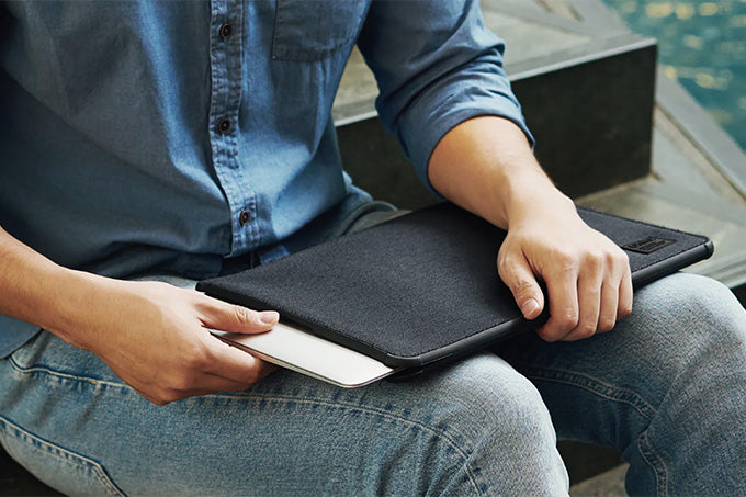 Image of a person sitting with his laptop