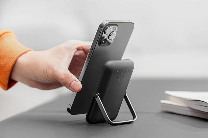 Image of an iPhone and charger with stand