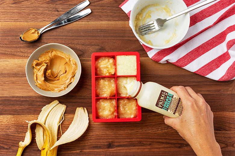 Primal Peanut Butter Pupsicles Step 4 - Adding raw goat milk to ice tray