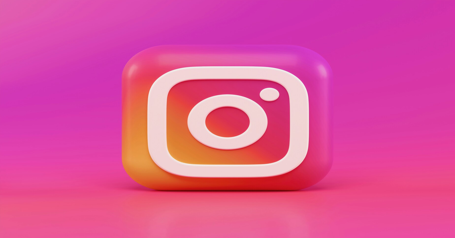 Das Instagram Logo vor einem pinken Hintergrund.