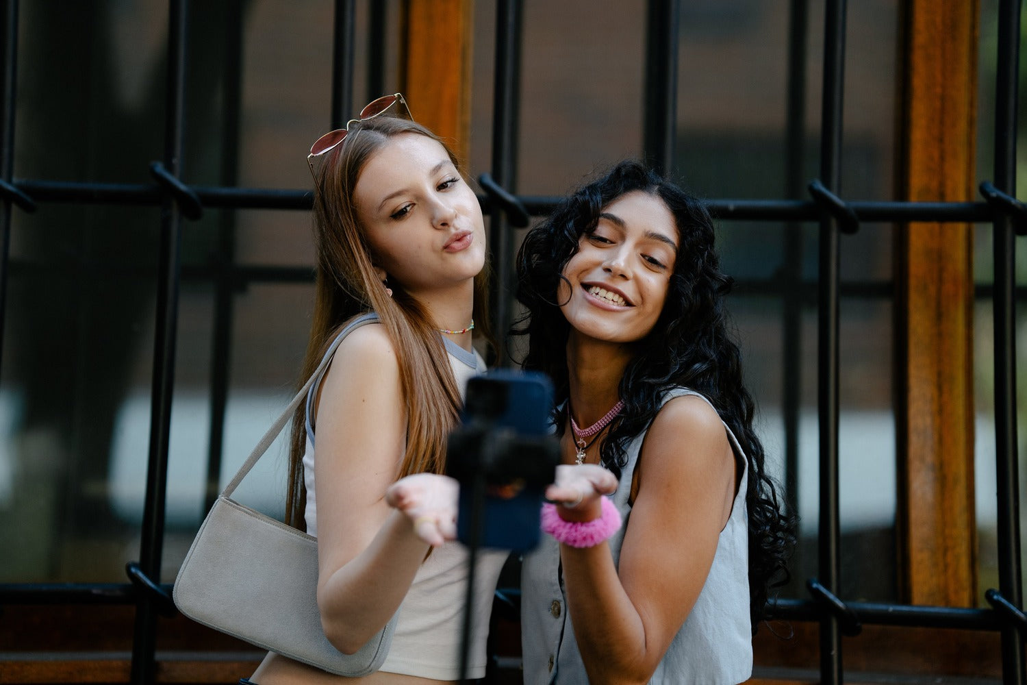 Zwei junge Frauen posieren vor einer Kamera