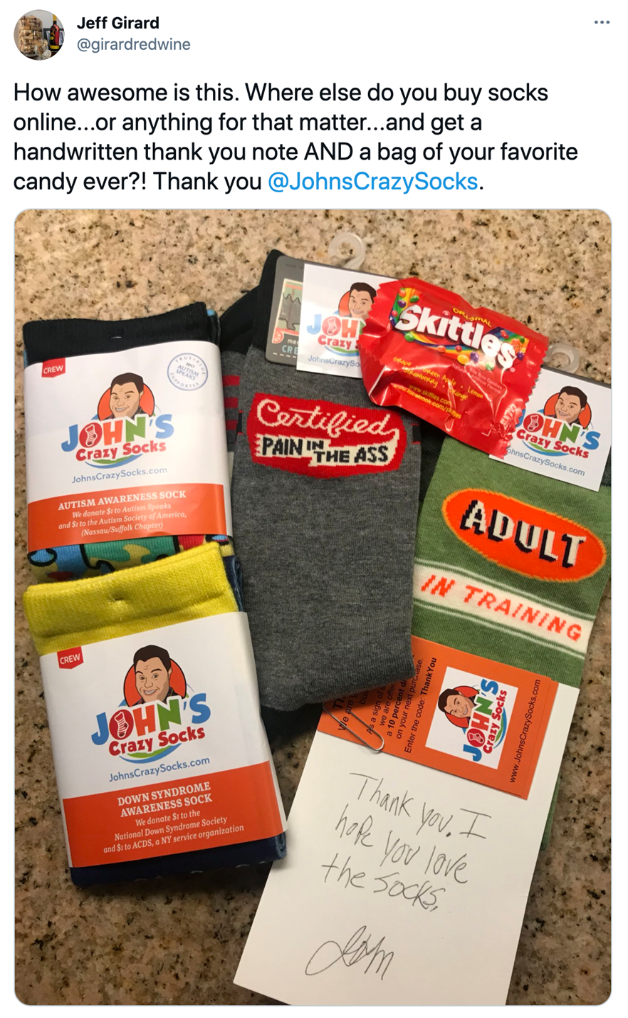 Ein Foto einer Produktlieferung von Johns Crazy Socks. Beim Versand wird immer eine persönliche Dankeskarte geschrieben um ein Danke an Kund:innen zu versenden.