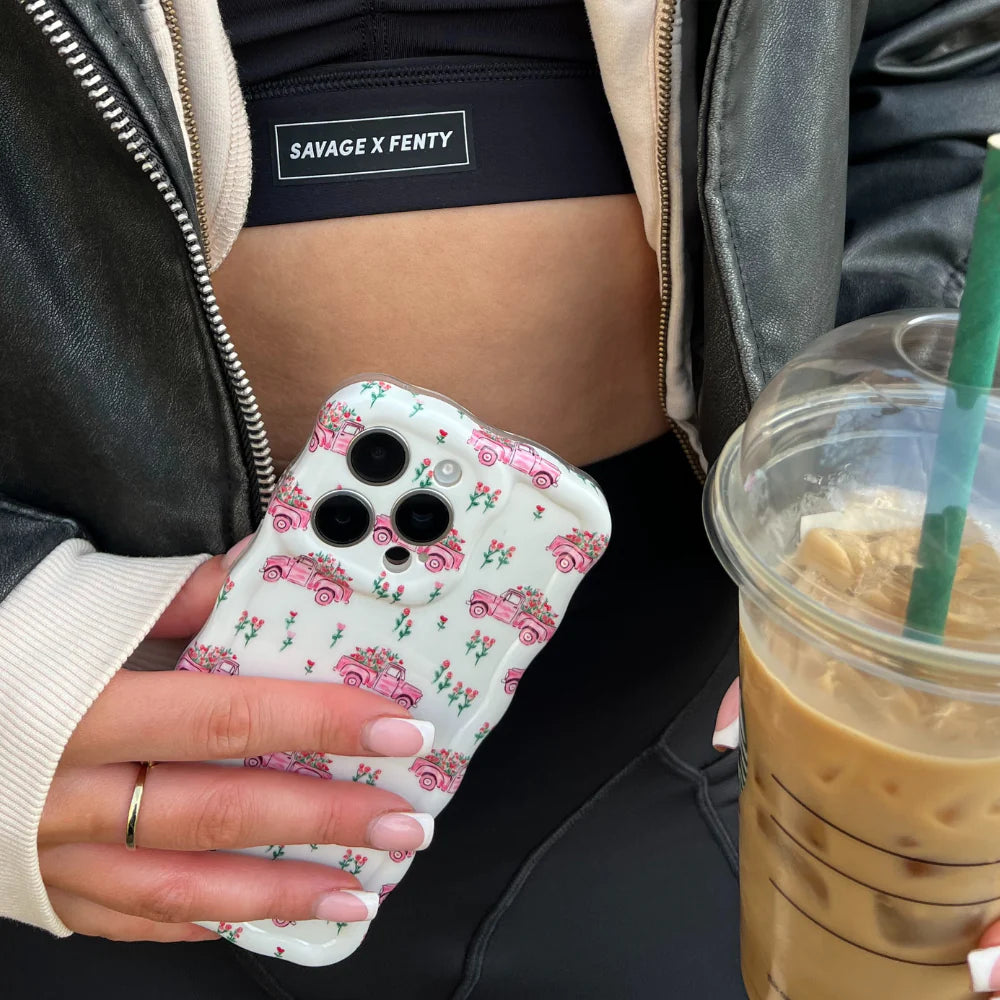 Cozy scene with floral-themed phone case, AirPods, and pink latte at Peggy Porschen, London.
