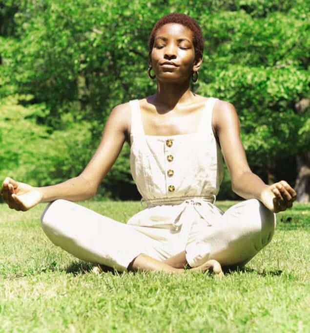 woman meditating to promote holistic health and fitness