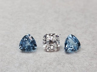 Triangle sapphires flanking center diamond