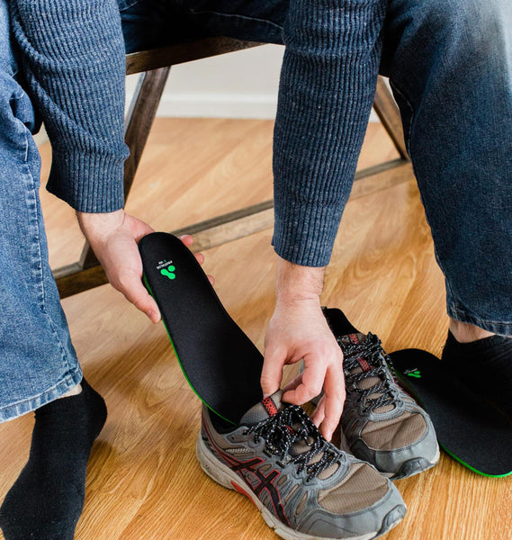 Man putting Protalus T-100 Elite insoles into sneakers