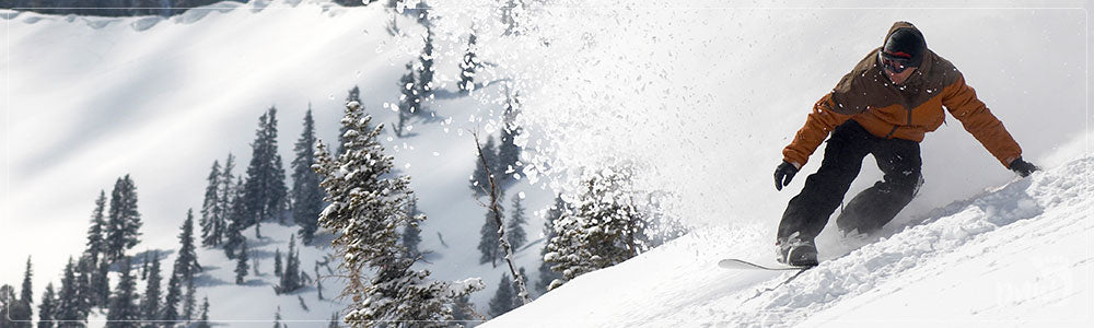 Snowboarder Carving Down a Mountain - PNW Life Featured Image