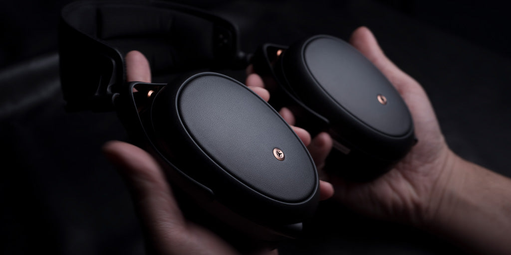 Meze Audio LIRIC Closed-Back Planar Magnetic Headphones - Hands holding LIRIC | Headphones.com