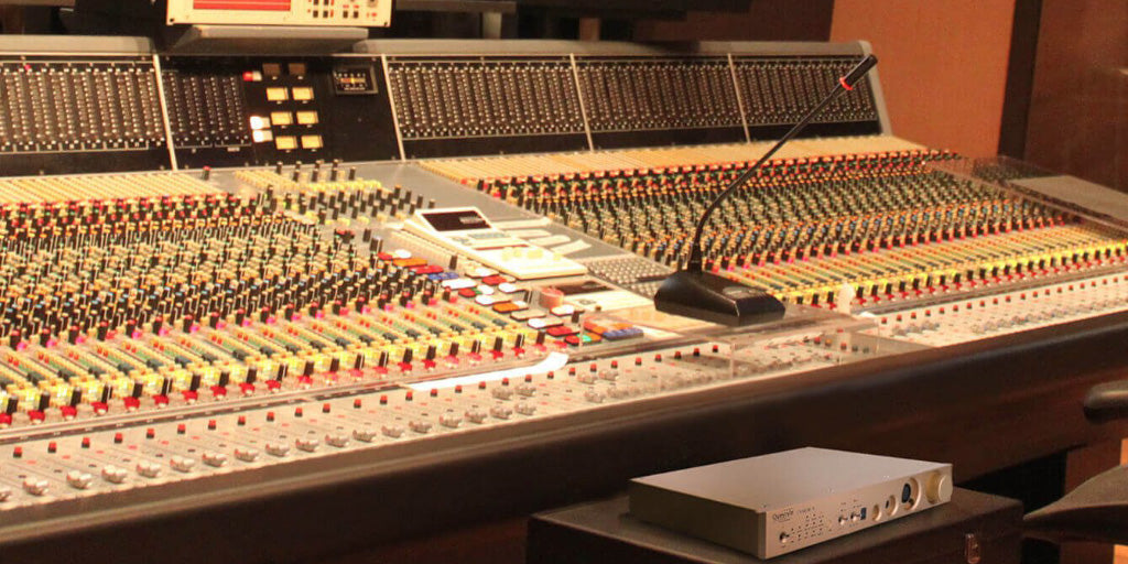 Questyle CMA Twelve amplifier, shown in recording studio | Headphones.com