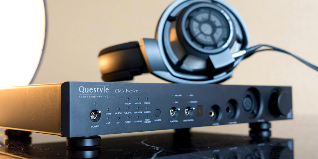 Questyle CMA Twelve amplifier, amp shown with headphones | Headphones.com