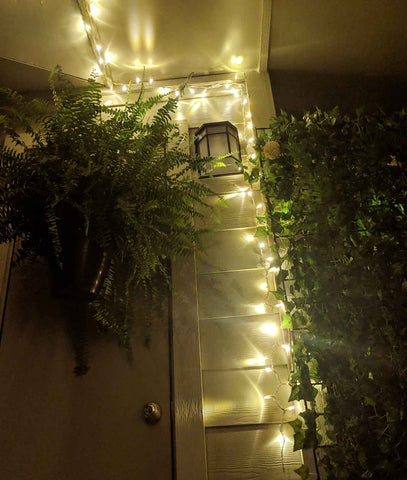 cozy string lights on a plant filled balcony