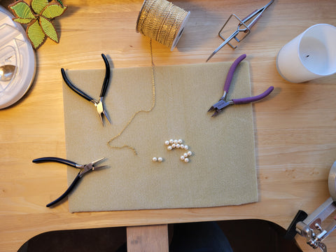 Overview of jewelry tools, pearls and chain on my workbench