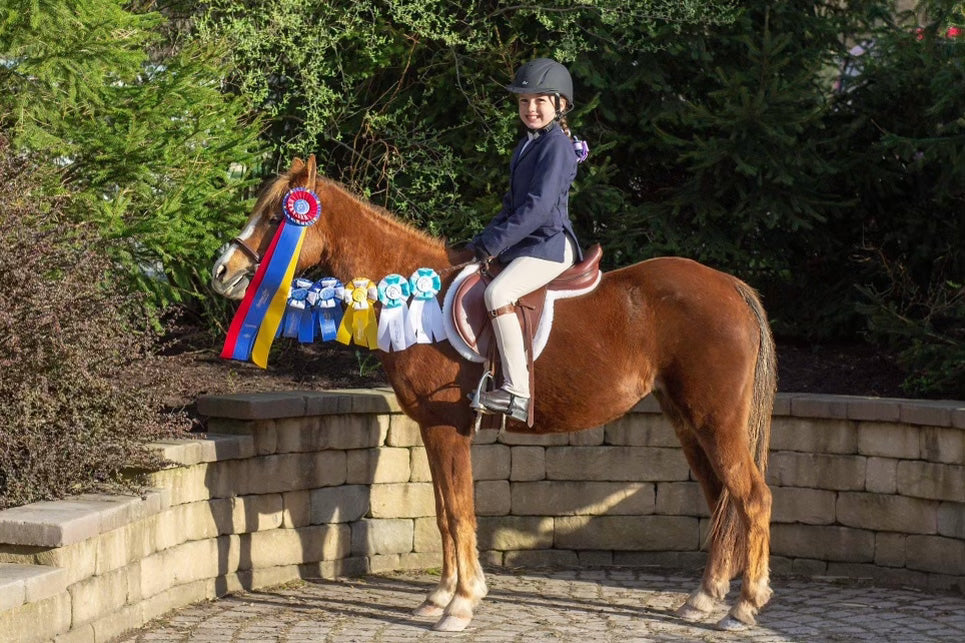 Arianna Johnson posing with all of her medals