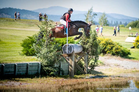 Ryleigh Leavitt jumping her brown horse
