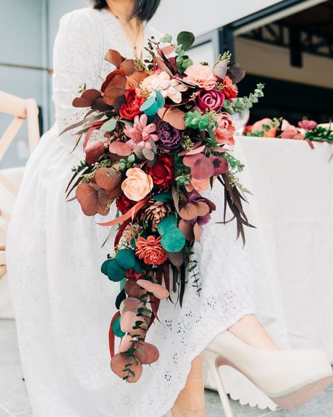 Beautiful Bride in Nature with Sola Wood Flowers Bouquet on Her Wedding Day