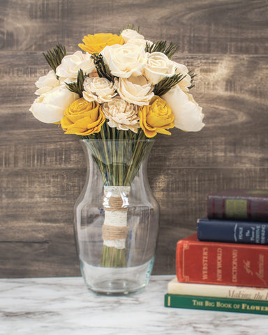 Yellow and white sola flowers in a glass vase