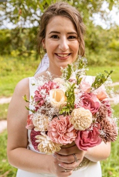 Blonde Bride Smiling Outdoors with Bouquet of Sola Wood Flowers - Wedding Beauty and Romance.