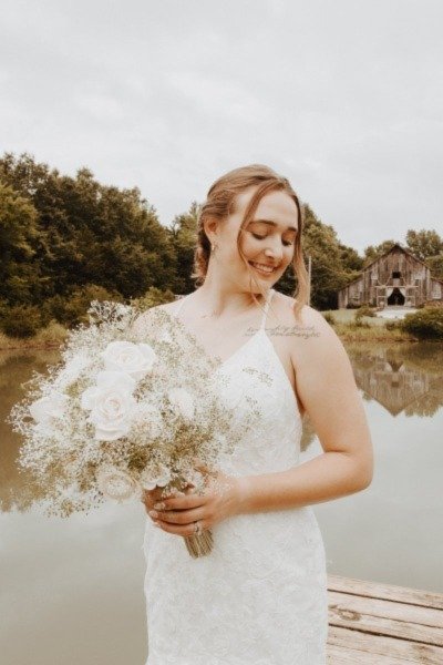 Two Cheerful Women in Wedding Dresses Smiling with Sola Wood Flowers Bouquets in Happiness.