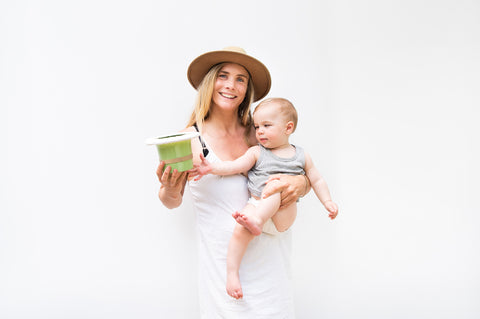 Mother holding baby with Top Hap Potty for Elimination Communication