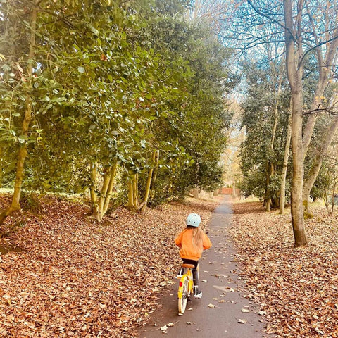 Child riding a yellow 20 inch bobbin bike