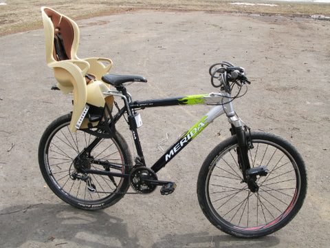 Adult bike with a child beak seat attached on the rear