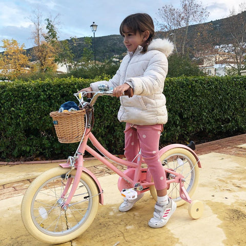 Child riding a pink 16 inch bobbin bike