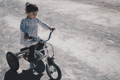 A child riding a tricycle bike