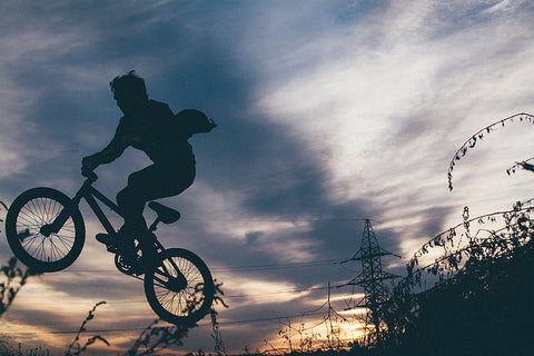 A silhouette of a BMX rider performing a freestyle ride.