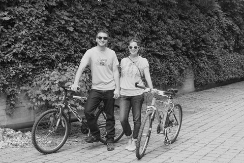 A couple on a bike date, posing with their bikes in Munich.