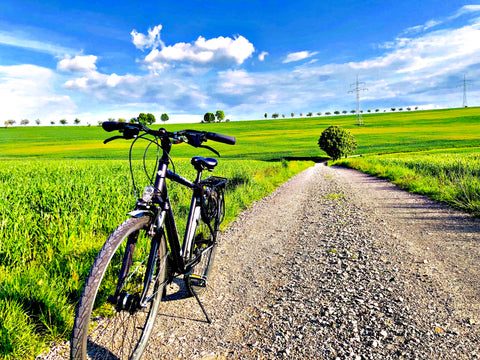 A photo of a bicycle parked on a countryside road