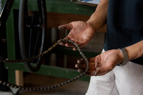 A person holding a bike chain