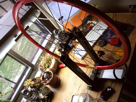 A bicycle wheel on a truing stand.