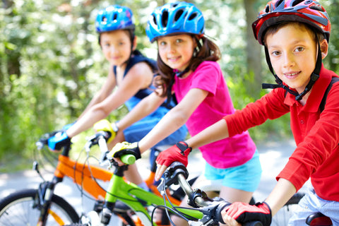 A small group of kids on their bikes in full gear