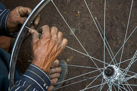 A person fixing a bike wheel rim