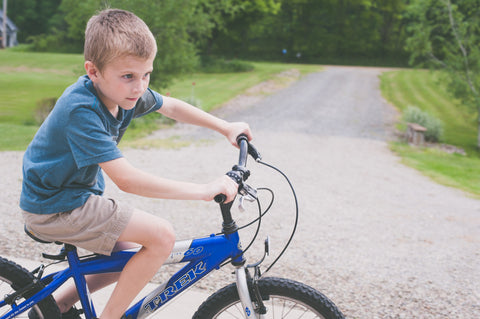 A kid riding a hybrid bike