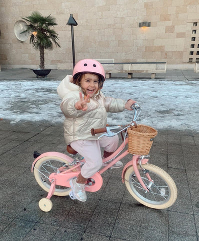 snow child pink bike with basket peace sign