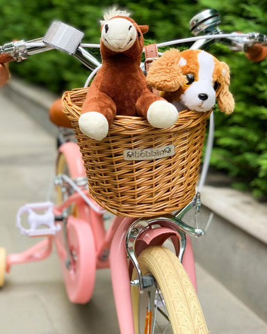 teddy horse and dog in kids pink bike basket gingersnap