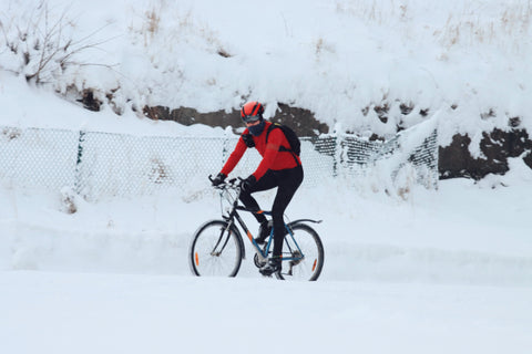 A person riding a bike in the snow