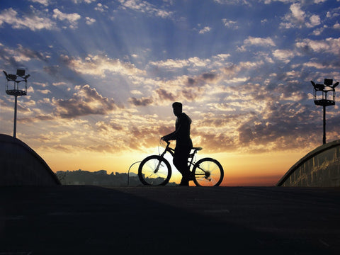 Silhouette of a man on his bike 