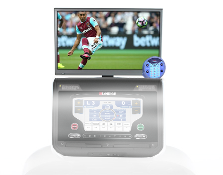 A man in a west ham jersey is kicking a soccer ball on a tv